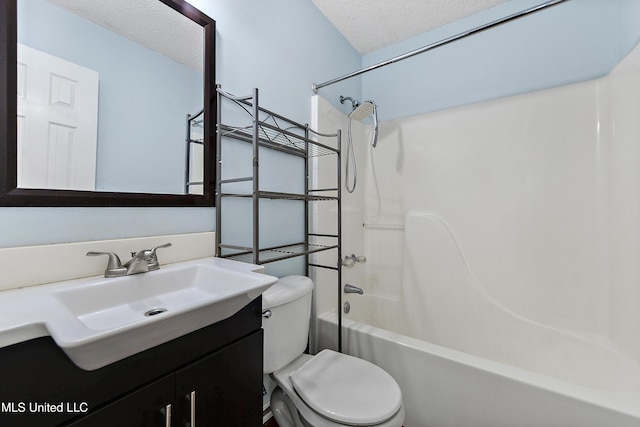 full bathroom featuring vanity, bathtub / shower combination, a textured ceiling, and toilet