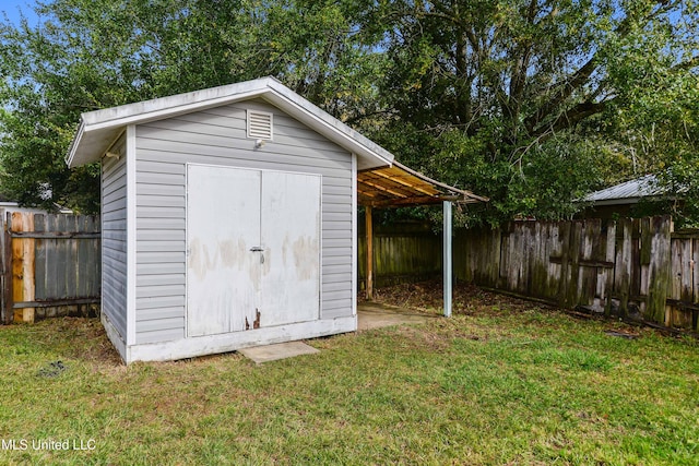 view of outbuilding featuring a yard