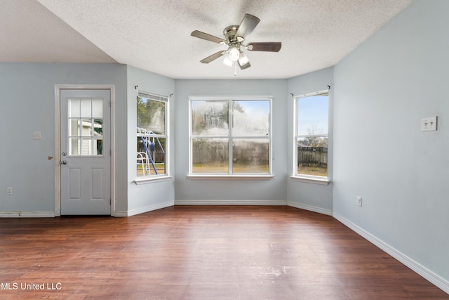 interior space featuring hardwood / wood-style flooring, ceiling fan, and a textured ceiling