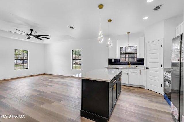 kitchen with a sink, recessed lighting, a ceiling fan, and visible vents