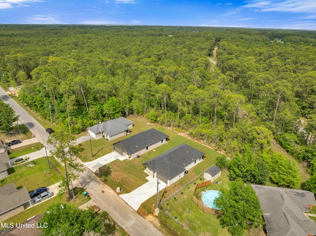 birds eye view of property with a wooded view