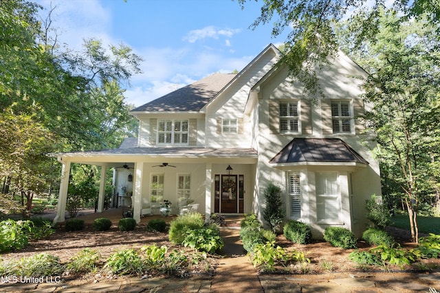 view of front of property with a ceiling fan, covered porch, and roof with shingles