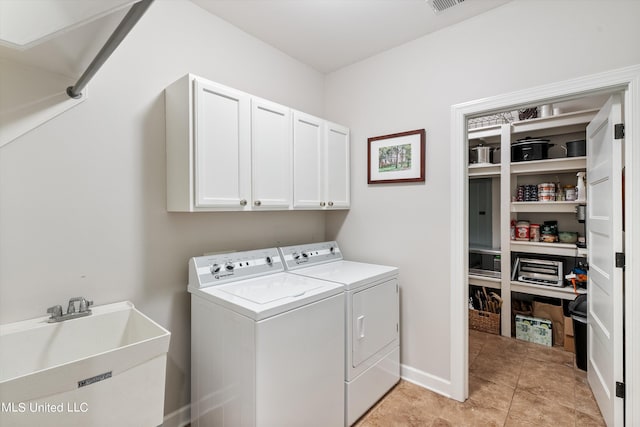 laundry area featuring cabinet space, independent washer and dryer, light tile patterned floors, and a sink