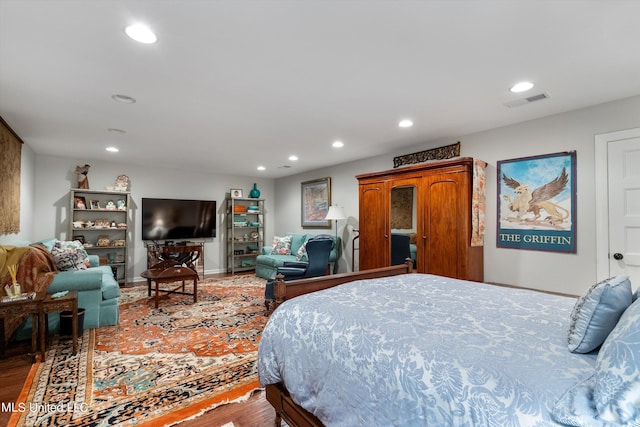 bedroom featuring recessed lighting, wood finished floors, visible vents, and baseboards