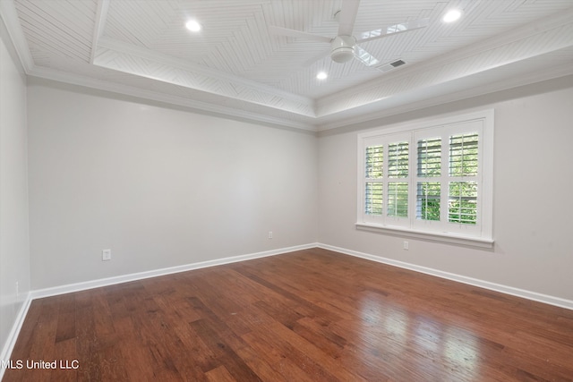 empty room with wood finished floors, a ceiling fan, baseboards, and crown molding