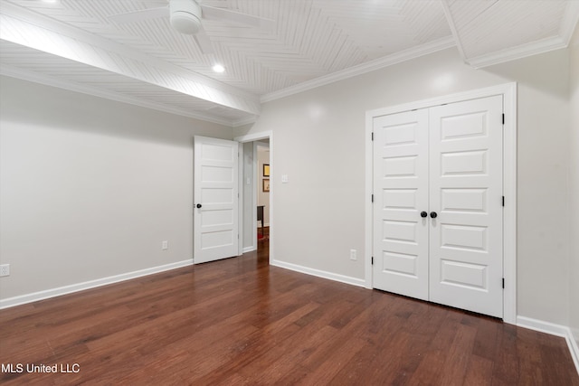 below grade area featuring crown molding, baseboards, a ceiling fan, and wood finished floors