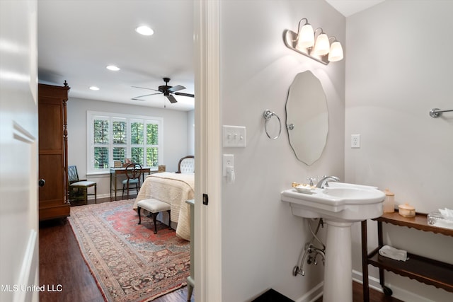 bathroom with wood finished floors, connected bathroom, ceiling fan, baseboards, and recessed lighting