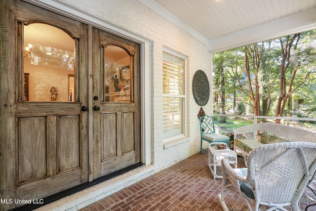 doorway to property with brick siding