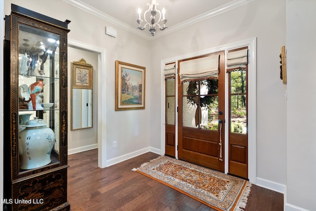 foyer with dark wood-type flooring, baseboards, a chandelier, and crown molding