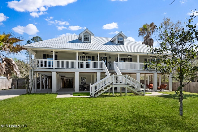 view of front of house with ceiling fan, a front yard, and a porch