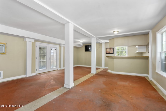 basement with french doors and a healthy amount of sunlight