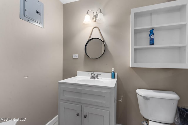 bathroom featuring toilet, electric panel, and vanity