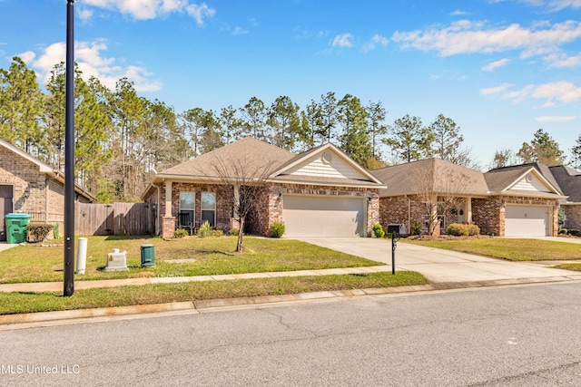 view of front facade with brick siding, a front lawn, fence, a garage, and driveway