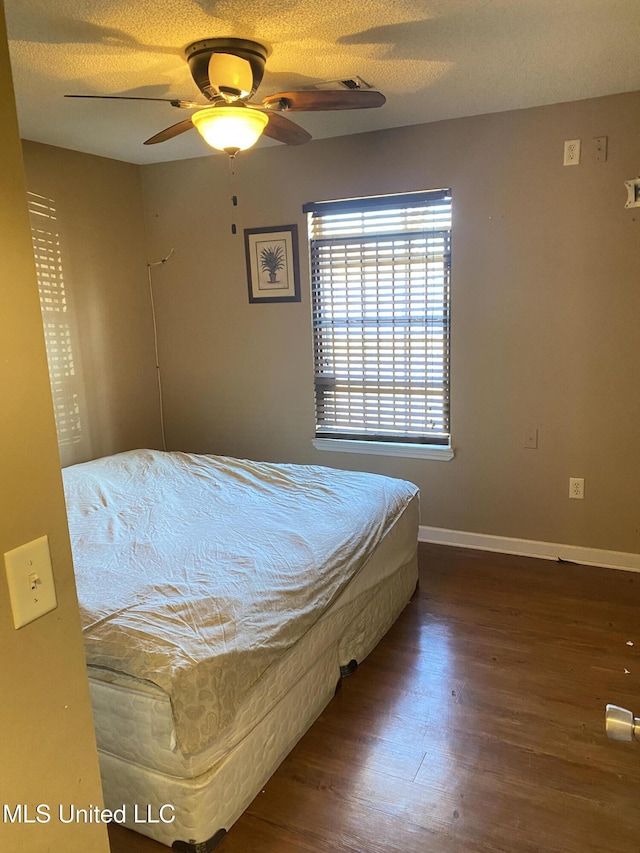 bedroom with ceiling fan and hardwood / wood-style floors