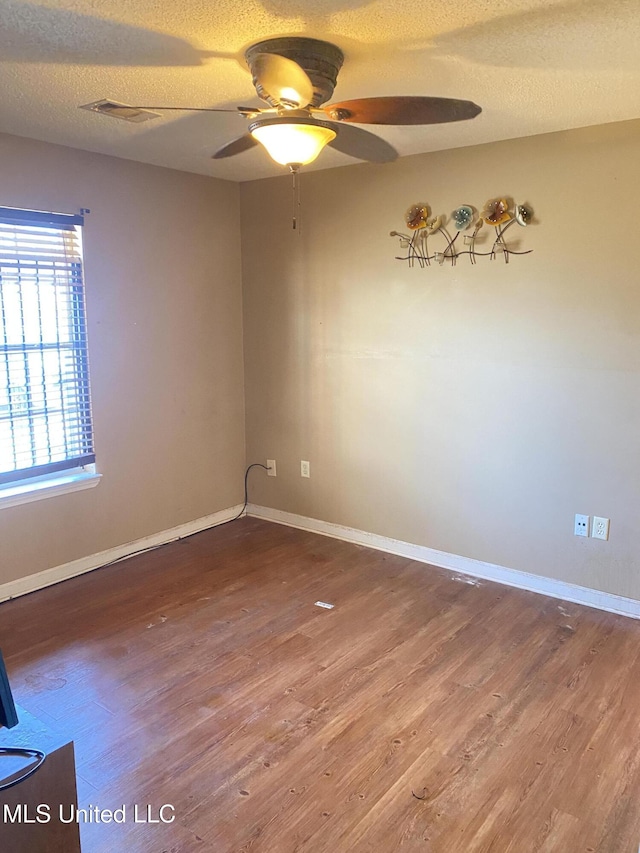 unfurnished room with hardwood / wood-style flooring, a textured ceiling, and ceiling fan