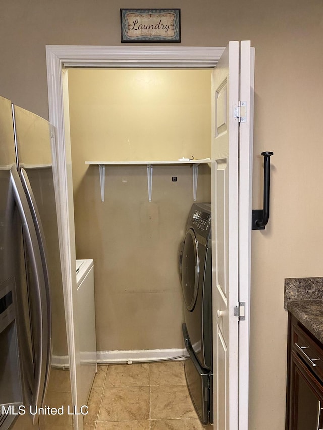 laundry area with light tile patterned floors and independent washer and dryer