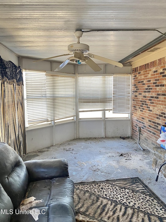 unfurnished sunroom with ceiling fan