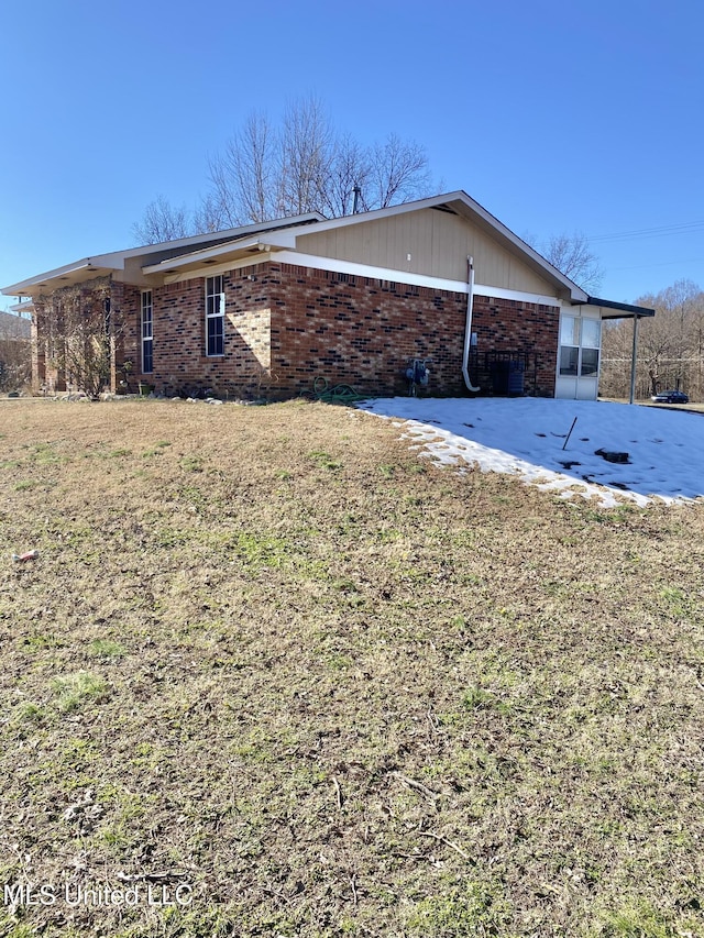 view of property exterior with a lawn and a patio area