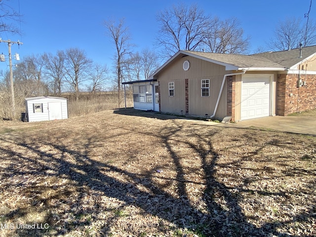 view of side of property with a storage unit and a garage