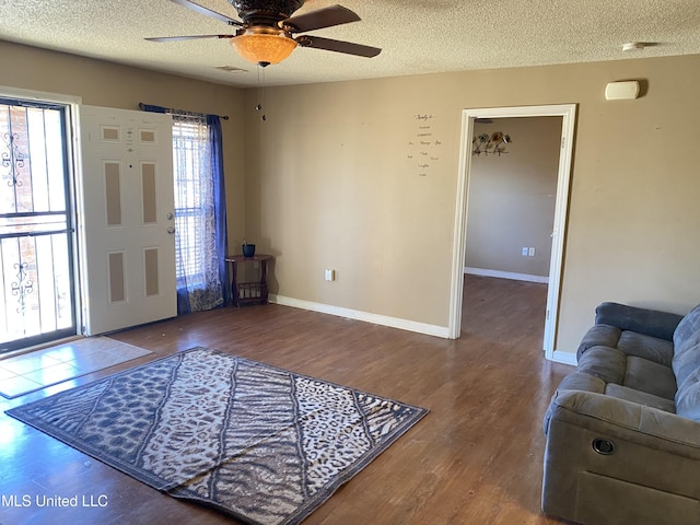 entrance foyer featuring a textured ceiling, ceiling fan, and hardwood / wood-style floors