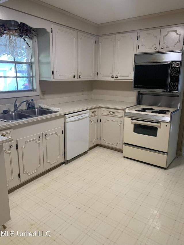 kitchen featuring white cabinetry, sink, white appliances, and ornamental molding