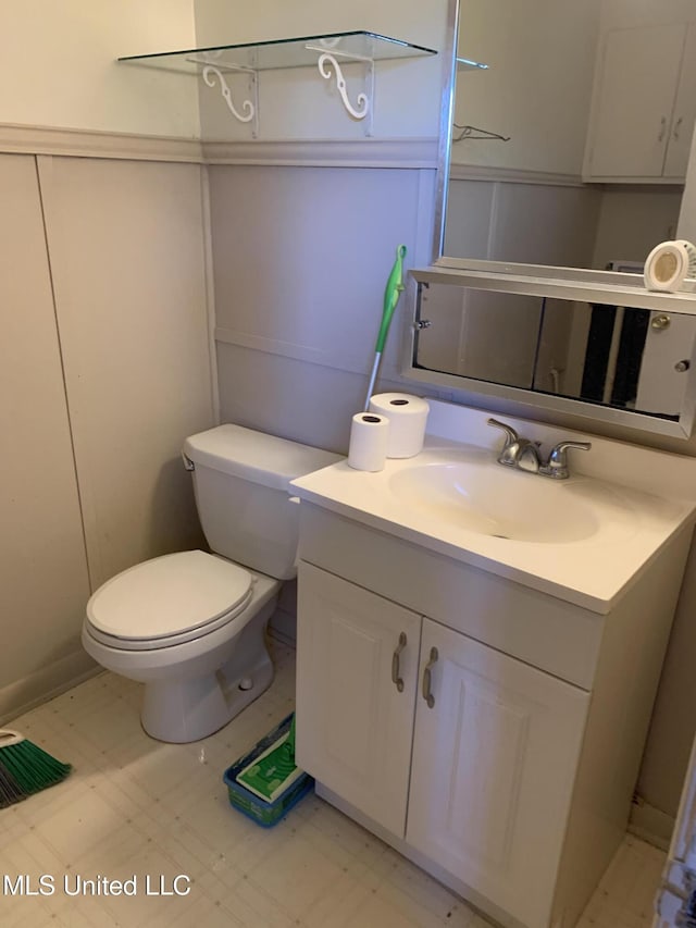 bathroom featuring vanity and toilet