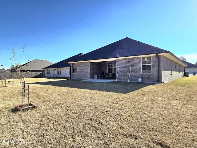 rear view of house with a patio area and a yard