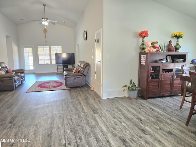 living room featuring hardwood / wood-style floors, ceiling fan, and high vaulted ceiling