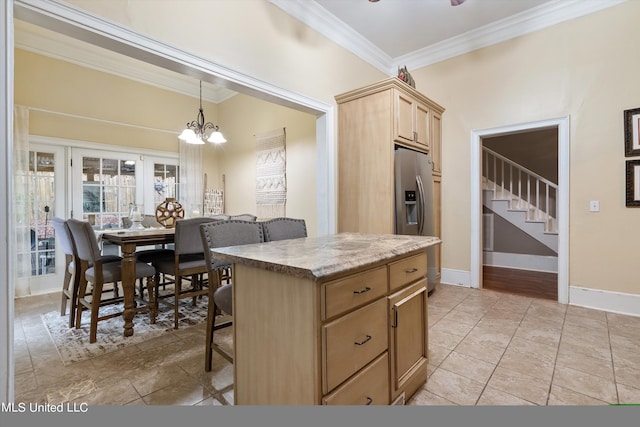 kitchen featuring a kitchen breakfast bar, light brown cabinetry, a center island, ornamental molding, and decorative light fixtures