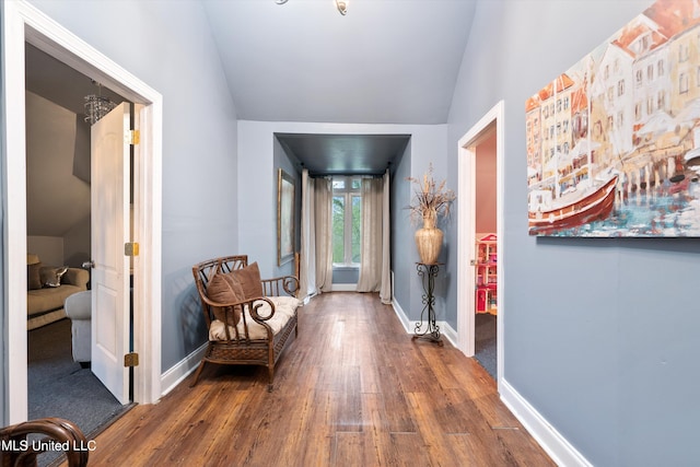 corridor with lofted ceiling and dark hardwood / wood-style floors