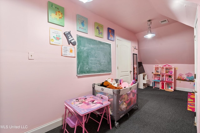 recreation room with vaulted ceiling and dark colored carpet