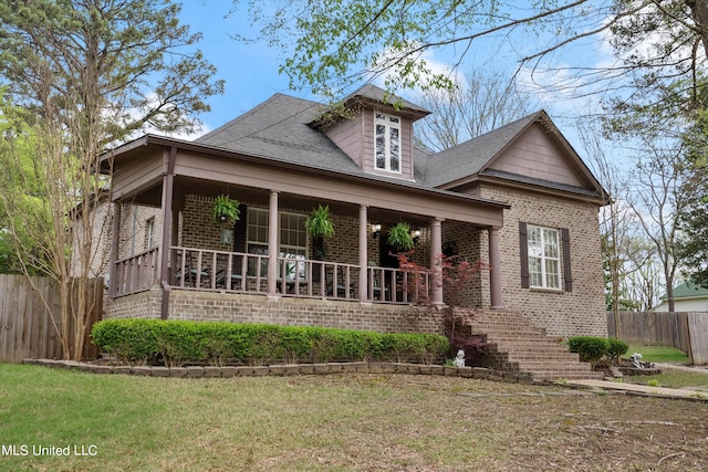 view of front of house featuring covered porch and a front yard