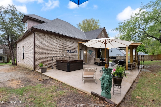 rear view of property featuring a patio area