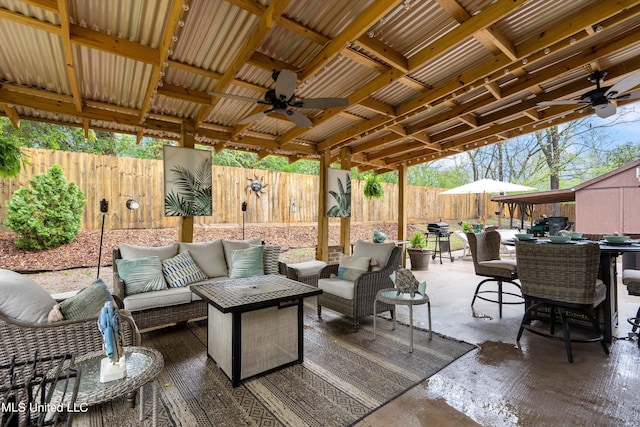 view of patio featuring a storage unit, an outdoor living space, and ceiling fan