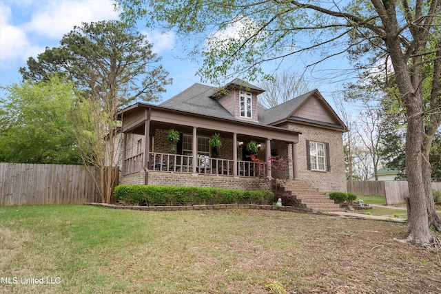 view of front of property with a front yard and covered porch