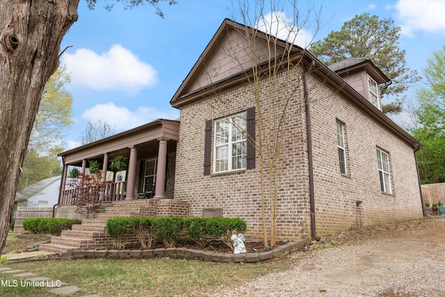 view of side of property with covered porch