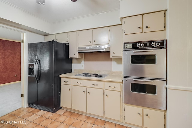 kitchen with appliances with stainless steel finishes, crown molding, and light tile patterned floors