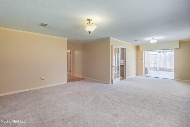 carpeted empty room with crown molding and a textured ceiling