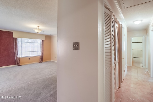 hall featuring light carpet, crown molding, and a textured ceiling