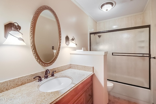 full bathroom featuring vanity, crown molding, enclosed tub / shower combo, and toilet