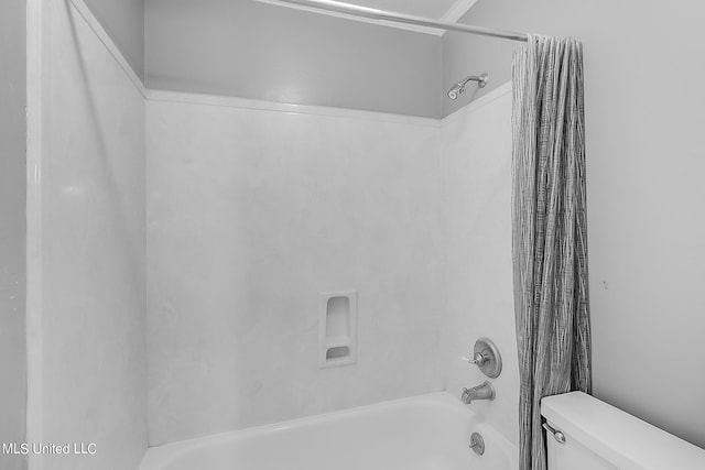 bathroom with shower / tub combo and toilet