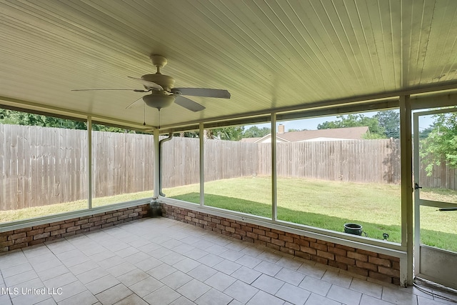 unfurnished sunroom with ceiling fan and a wealth of natural light