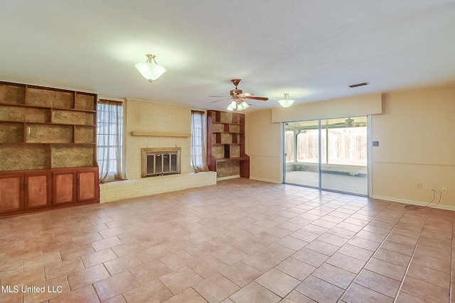 unfurnished living room featuring a fireplace and ceiling fan