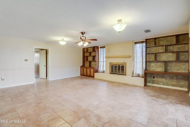 unfurnished living room featuring a fireplace, built in features, and ceiling fan