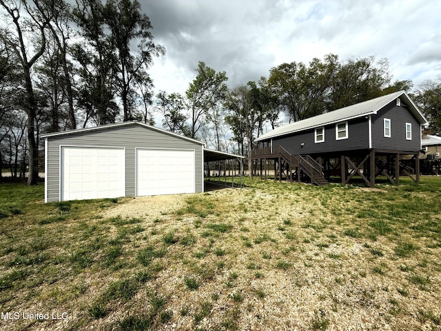 2997 Deerfield Rd, Yazoo City, MS 39194 - view of green lawn with an outdoor structure, a garage, and stairway