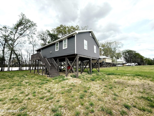 2997 Deerfield Rd, Yazoo City, MS 39194 - rear view of house with stairway, a lawn, and a wooden deck