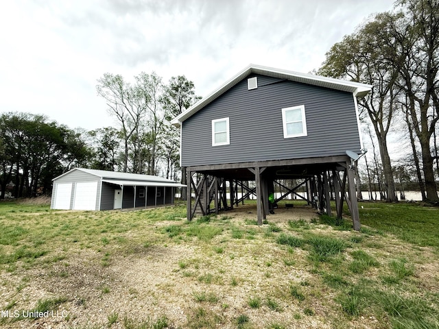 2997 Deerfield Rd, Yazoo City, MS 39194 - rear view of property featuring a garage, an outbuilding, and stairs