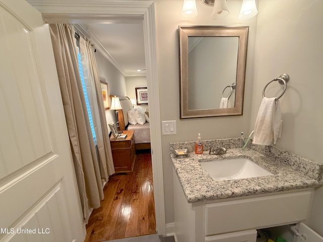 2997 Deerfield Rd, Yazoo City, MS 39194 - ensuite bathroom with hardwood / wood-style flooring, vanity, and ornamental molding