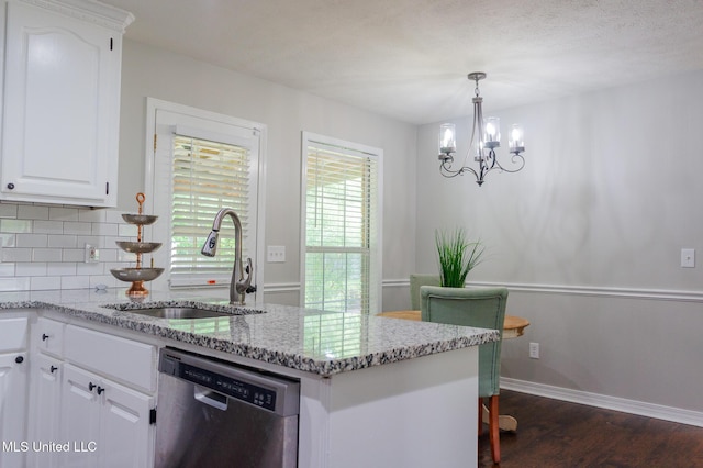 kitchen featuring stainless steel dishwasher, a sink, dark wood-type flooring, a chandelier, and white cabinets