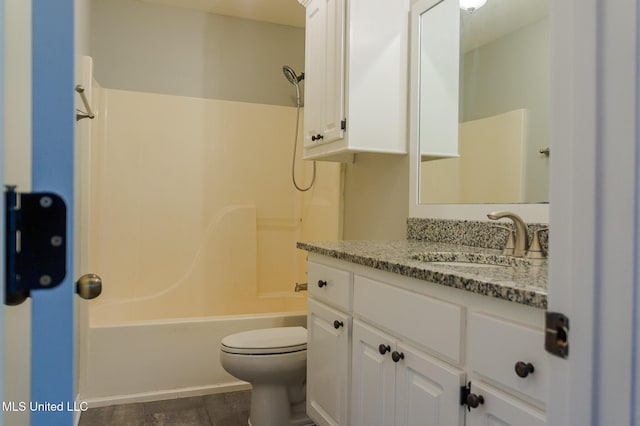 bathroom featuring toilet, bathtub / shower combination, and vanity